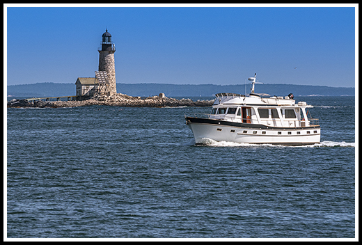 boat passes by Halfway rock light