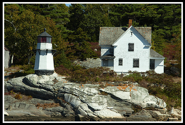 Perkins Island lighthouse on rocky shoreline