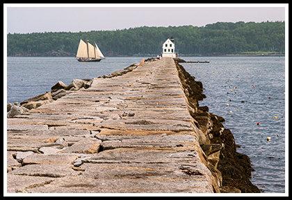 schooner approaches lighthouse at end of Rockland breakwater