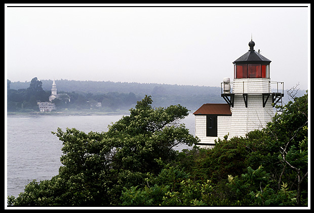 Squirrel Point light with church across the river