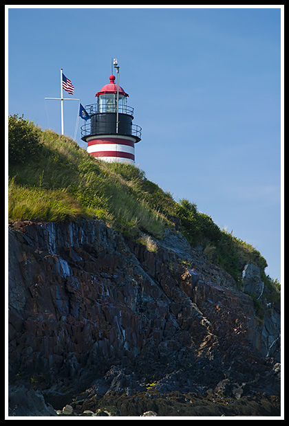 tower of West Quoddy Head lighthouse over cliffs