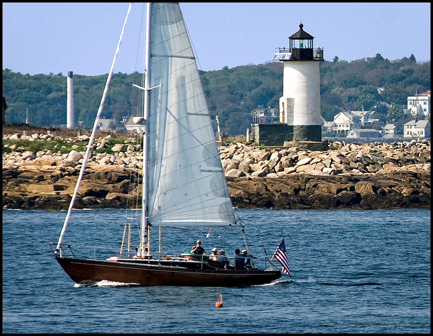 sailboat passes by Straitsmouth Island light
