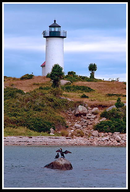 Tarpaulin Cove lighthouse tower by shoreline