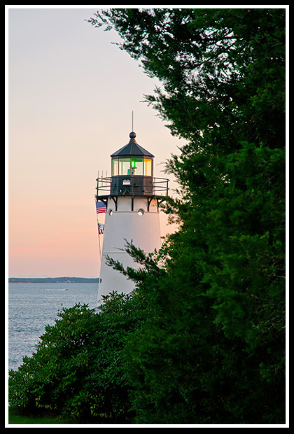 Warwick harbor lighthouse tower during sunset.