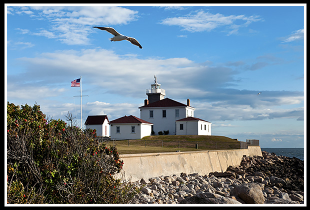 Watch Hill lighthouse along protective seawall